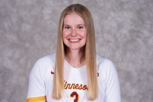 A smiling athlete with long blonde hair wears a white jersey with "Minnesota" and the number 3, standing against a textured gray background.